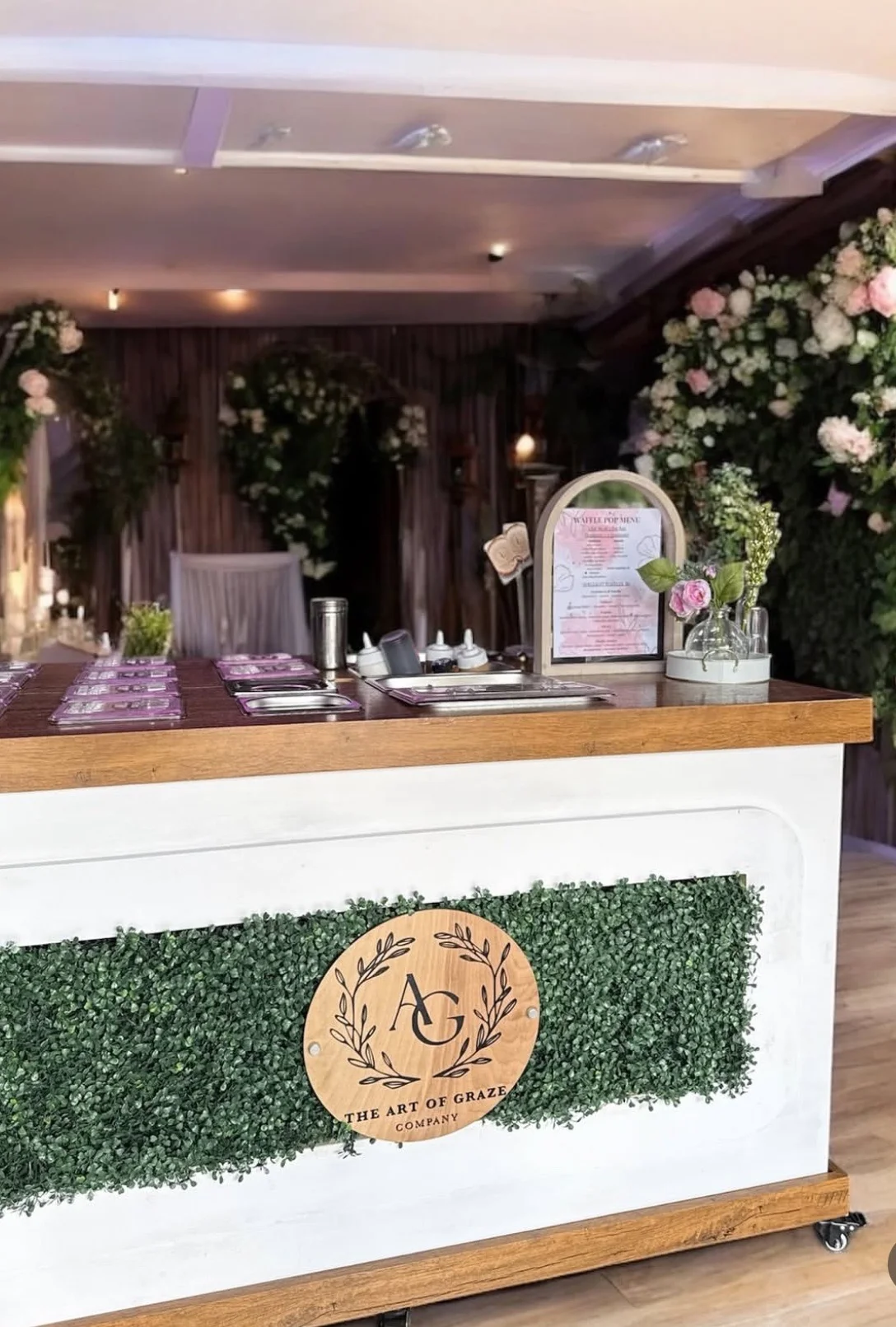 The Art of Graze — custom round wood logo sign on catering bar, business branding Estero Florida