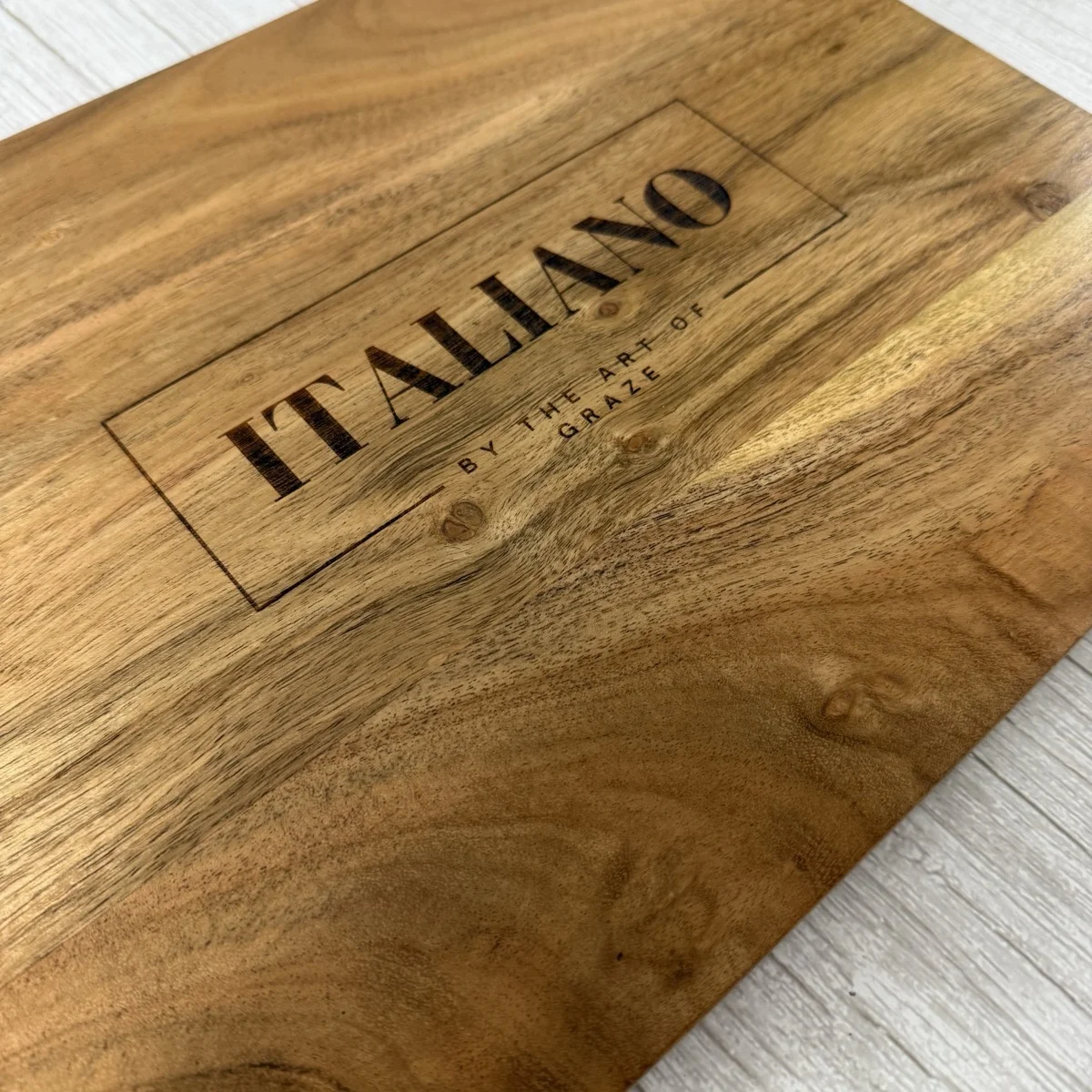 Branded acacia wood charcuterie board — custom laser engraved logo for Italiano, corporate gift Southwest Florida