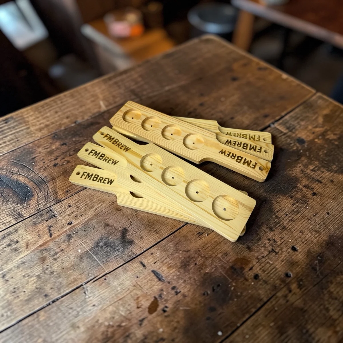 Custom laser engraved beer flight paddles — branded wood serving boards for FM Brew, Palm Coast Customs Estero Florida