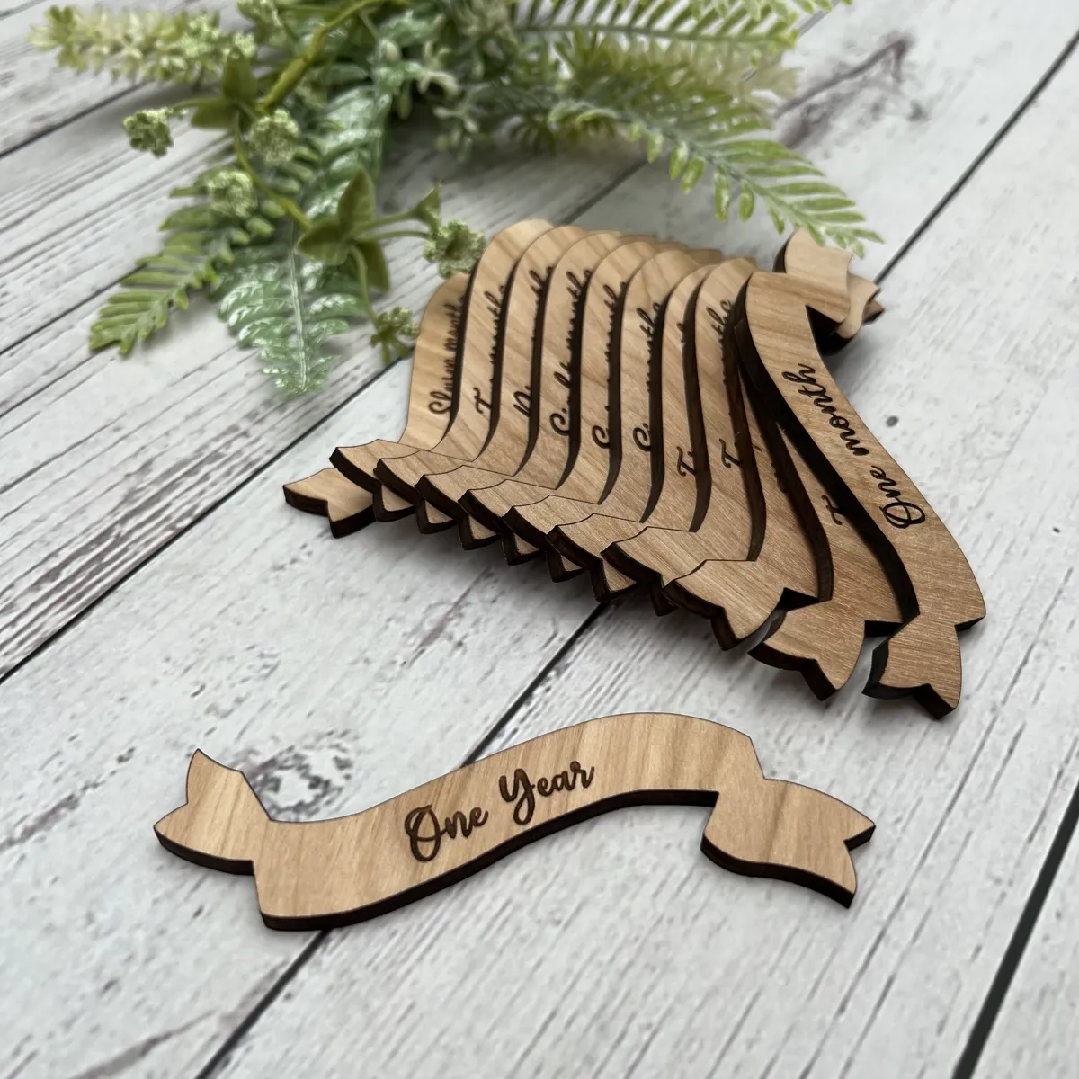 Laser cut wood milestone banner set — custom names and One Year celebration keepsakes