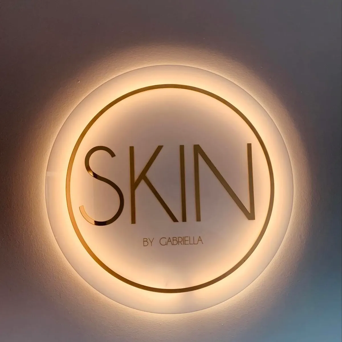 Skin by Gabriella — backlit round acrylic logo sign, custom laser engraving Estero Florida